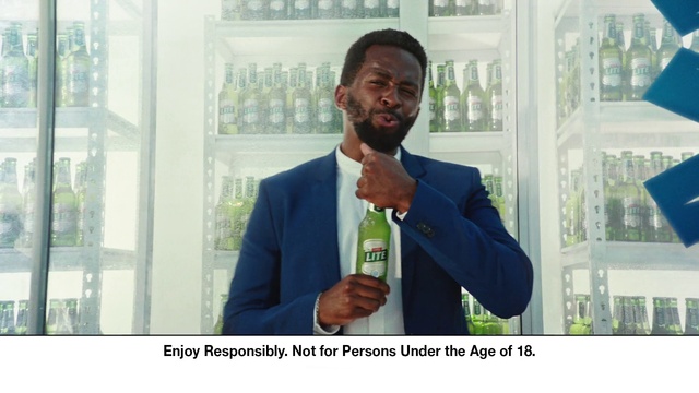 Video Reference: Microphone, Dress shirt, Coat, Gesture, Tie, Beard, Suit, Drink, White-collar worker, Formal wear