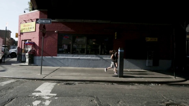 Video Reference: Road surface, Asphalt, Sidewalk, Public space, Road, Facade, Building, City, Human settlement, Pedestrian