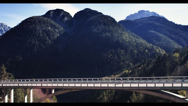 Video Reference: Mountain, Sky, Natural landscape, Tree, Highland, Body of water, Travel, Girder bridge, Morning, Mountainous landforms