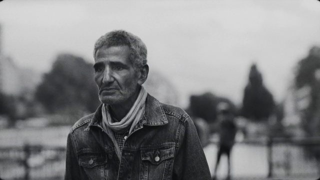 Video Reference: Outerwear, Sky, Flash photography, Beard, Standing, Black-and-white, Style, Grey, Leather jacket, Jacket