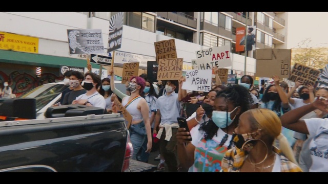 Video Reference: Car, Vehicle, Handwriting, Motor vehicle, Vehicle door, Event, Automotive exterior, Bumper, Hat, Crowd