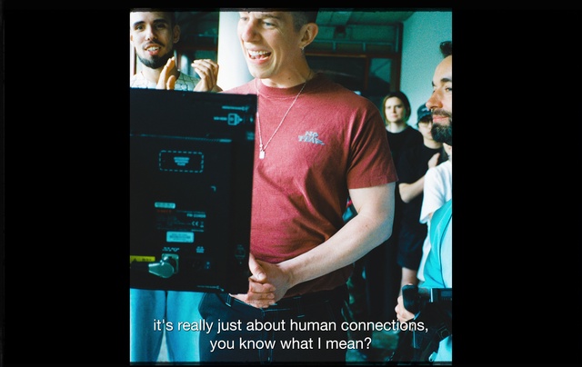 Video Reference: Smile, Flash photography, Gesture, Entertainment, Font, T-shirt, Audio equipment, Music artist, Electronic device, Event
