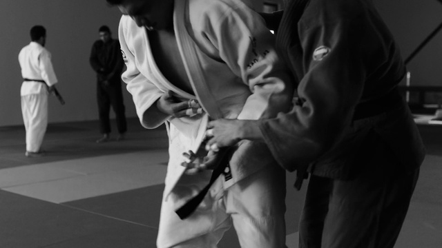 Video Reference: Dobok, Sports uniform, Martial arts uniform, Karate, Gesture, Black-and-white, Style, Japanese martial arts, Combat sport, Contact sport