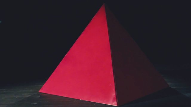 Video Reference: pyramid, geometric, red, abstract, sculpture, art, minimalist, dark background, studio, shapes, contemporary, installation