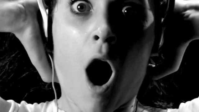 Video Reference: black and white, close-up, person, headphones, surprised, shocked, face, expression, portrait, music, gasp, dramatic, high contrast, reaction