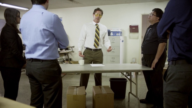 Video Reference: Trousers, Suit trousers, Table, Furniture, Dress shirt, Sleeve, Standing, Gesture, Engineering, White-collar worker