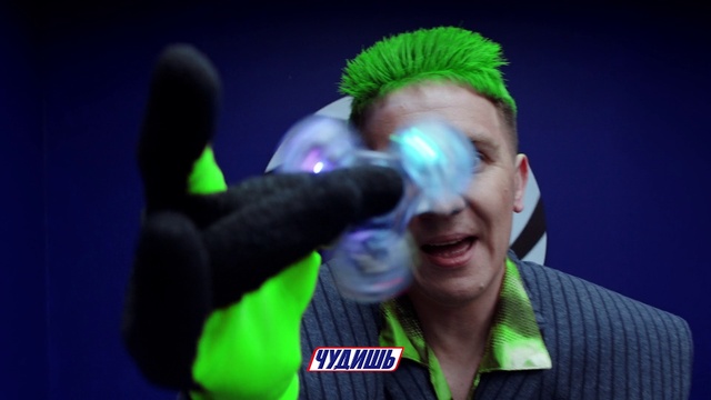 Video Reference: Green, Purple, Smile, Gesture, Entertainment, Headgear, Visual effect lighting, Magenta, Event, Electric blue