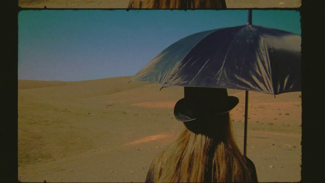 Video Reference: Umbrella, Shade, Headgear, Sky, Art, Landscape, Tints and shades, Travel, Feather, Aeolian landform