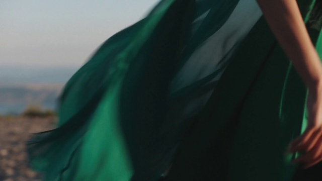 Video Reference: Outerwear, Sky, Sleeve, Tints and shades, Electric blue, Formal wear, Grass, Landscape, Wind, Shadow