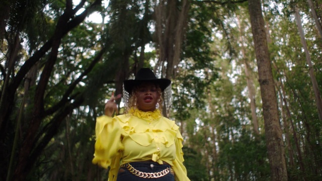 Video Reference: Hat, Natural environment, Leaf, Botany, Sun hat, Tree, Sleeve, Fedora, Terrestrial plant, Event