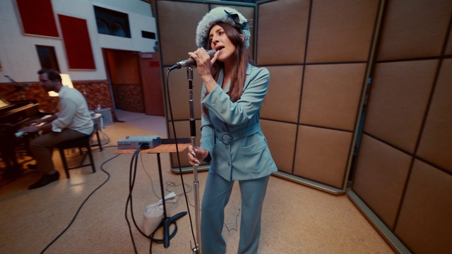 Video Reference: Face, Microphone, Public address system, Musician, Audio equipment, Entertainment, Performing arts, Chair, Music, Microphone stand