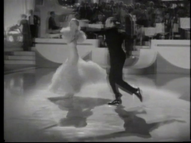 Video Reference: Standing, Flash photography, Sports equipment, Gesture, Black-and-white, Happy, Style, Performing arts, Flooring, Formal wear