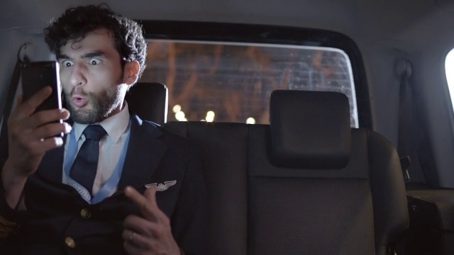 Video Reference: Flash photography, Beard, Gesture, Dress shirt, Bow tie, Suit, Blazer, Tie, Audio equipment, Gadget