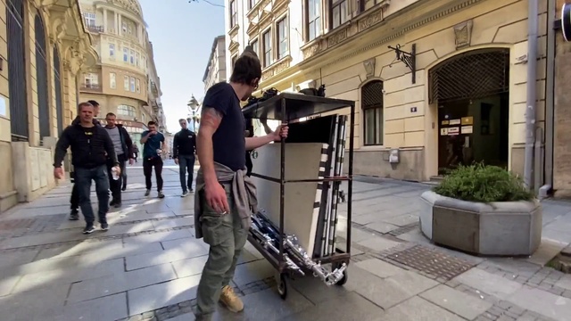 Video Reference: Building, Plant, Window, Infrastructure, Road surface, Street fashion, Sidewalk, Urban design, Public space, Road