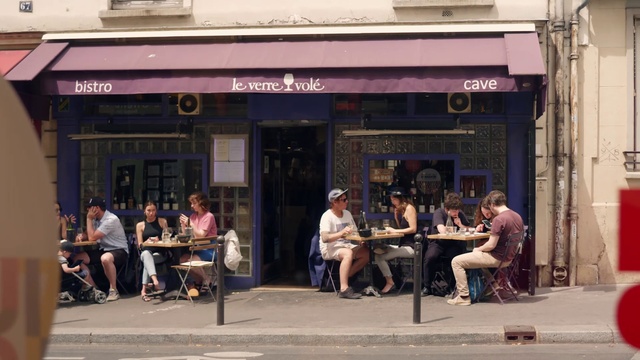 Video Reference: Clothing, Furniture, Table, Building, Leisure, Road, City, Facade, Chair, Event