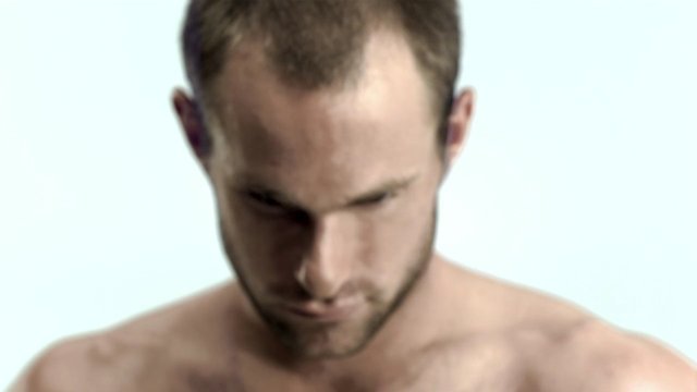 Video Reference: man, shirtless, portrait, close-up, looking down, head and shoulders, studio, plain background, male, adult, neutral expression, bare shoulders