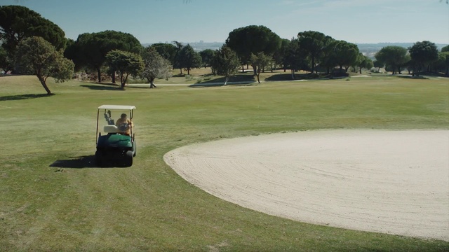 Video Reference: Sky, Golf cart, Golf, Tree, Plant, Natural environment, Vehicle, Tire, Golf equipment, Land lot