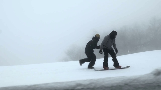 Video Reference: Skateboard deck, Sports equipment, Snow, Slope, Atmospheric phenomenon, Ice cap, Snowboarding, Terrain, Rolling, Fog