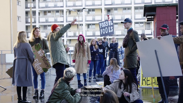 Video Reference: Outerwear, Window, Building, Coat, Hat, Jacket, Luggage and bags, Street fashion, City, Event