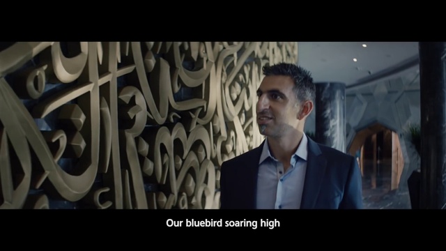 Video Reference: Flash photography, Blazer, Electric blue, Event, Formal wear, Darkness, Font, White-collar worker, Visual arts, Portrait photography