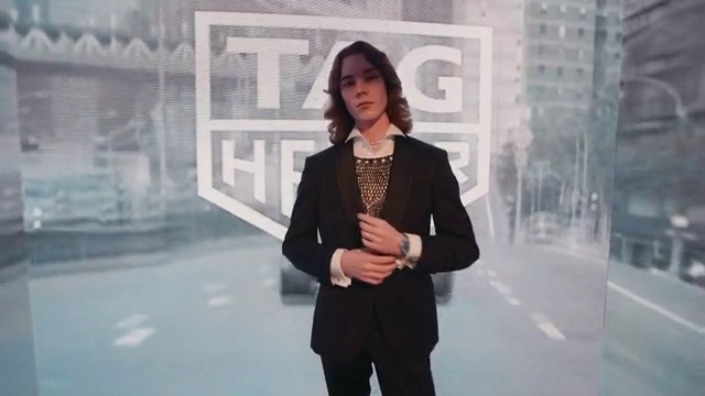 Video Reference: Flash photography, Sleeve, Standing, Gesture, Blazer, Formal wear, White-collar worker, Fashion design, Jewellery, Event