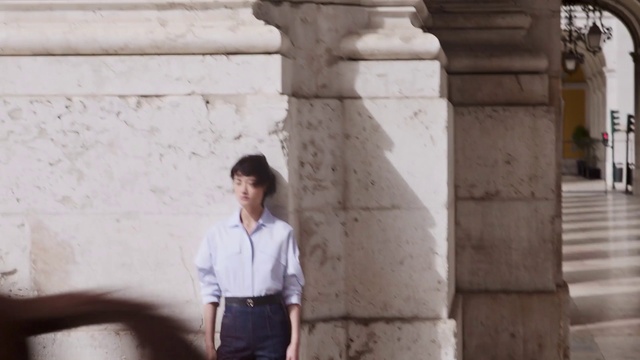 Video Reference: Sleeve, Temple, Standing, Dress shirt, Wall, Travel, People, Street fashion, T-shirt, Leisure