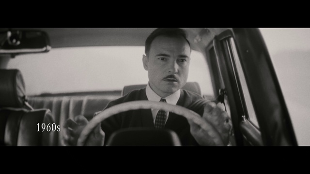 Video Reference: Flash photography, Jaw, Gesture, Automotive design, Style, Motor vehicle, Vehicle door, Movie, Tie, Eyewear