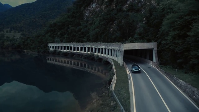 Video Reference: Water, Car, Vehicle, Tree, Plant, Road surface, Bridge, Asphalt, Road, Lake