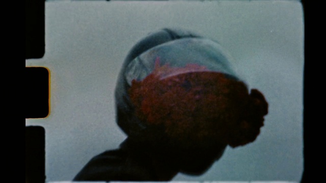 Video Reference: Jaw, Finger, Paint, Art, Helmet, Glass, Electric blue, Cap, Fashion accessory, Font