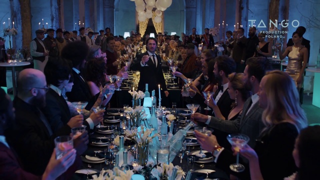 Video Reference: Shirt, Tableware, Table, Blue, Human, Wine glass, Lighting, Drinkware, Interaction, Curtain