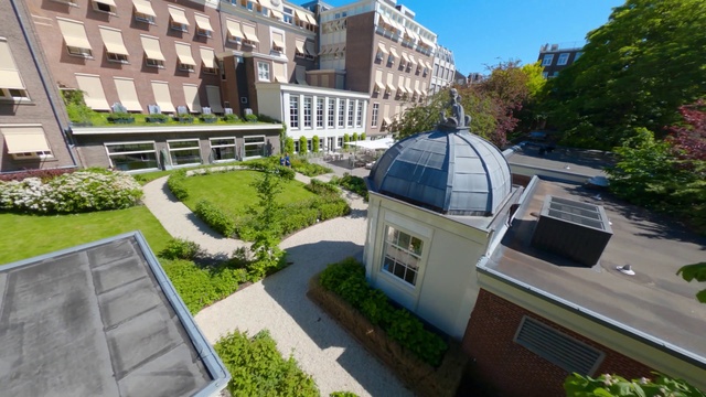 Video Reference: Plant, Building, Window, Sky, Urban design, Tree, Residential area, Public space, Condominium, Landscape