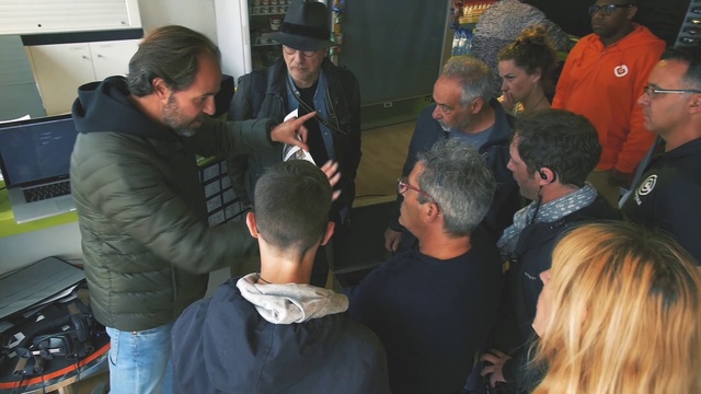 Video Reference: Shirt, Hat, Interaction, T-shirt, Fedora, Baseball cap, Jacket, Cap, Crowd, Event