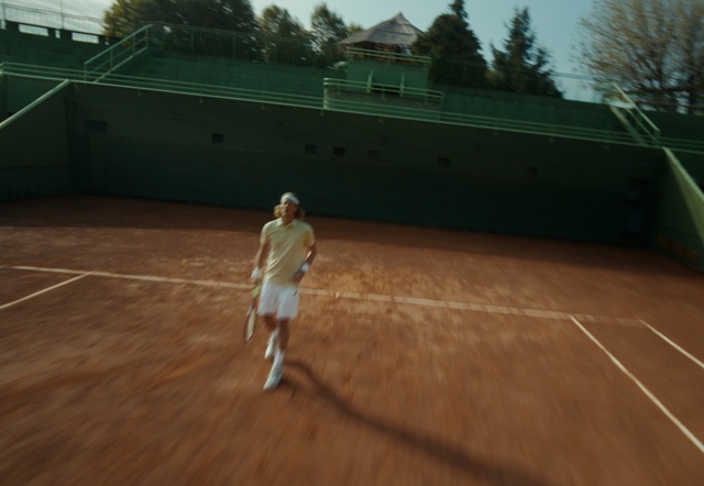 Video Reference: Sports equipment, Tennis player, Tree, Soft tennis, Tennis Equipment, Racquet sport, Tennis, Grass, Sky, Tennis court