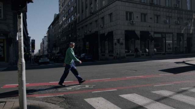 Video Reference: Building, Daytime, Window, Infrastructure, Road surface, Asphalt, Grey, Line, Sidewalk, Thoroughfare