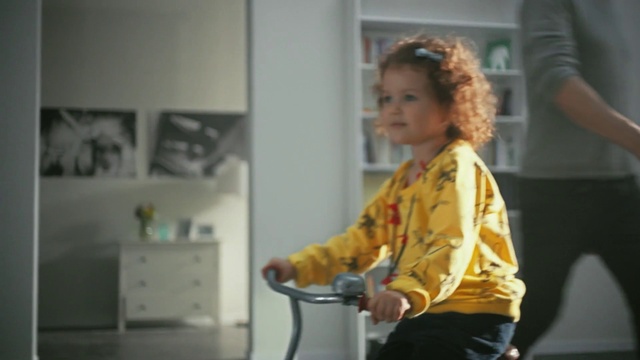 Video Reference: Bicycle handlebar, Cabinetry, Toddler, Drawer, Bicycle frame, Event, T-shirt, Recreation, Child, Room