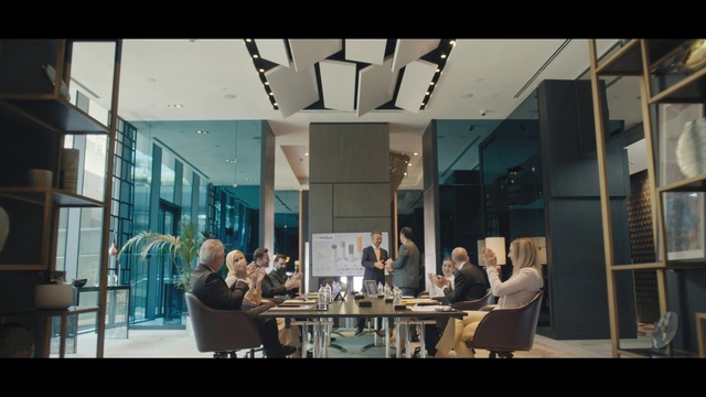 Video Reference: Building, Chair, Interior design, Table, Automotive design, Suit, Glass, Event, Ceiling, Space