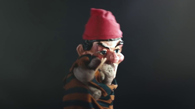 Video Reference: Beard, Santa claus, Gesture, Toy, Lawn ornament, Art, Facial hair, Garden gnome, Entertainment, Performing arts