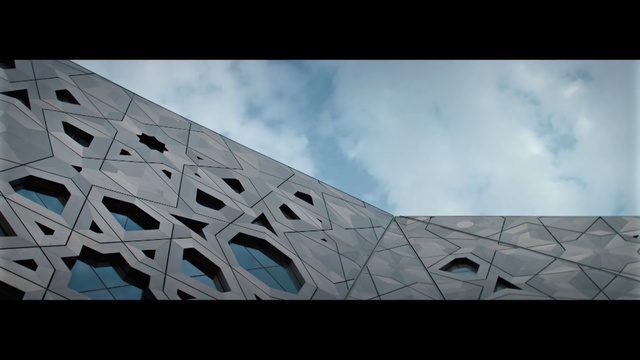 Video Reference: Cloud, Sky, Rectangle, Tints and shades, Composite material, City, Font, Urban design, Facade, Symmetry