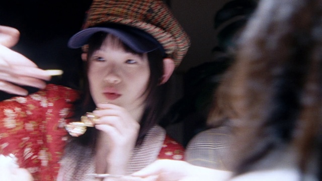 Video Reference: Lip, Mouth, Cap, Eyelash, Neck, Street fashion, Gesture, Headgear, Black hair, Nail