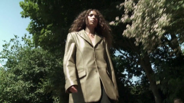 Video Reference: Shoulder, Plant, Flash photography, Neck, Tree, Overcoat, Sleeve, Collar, Grass, Waist