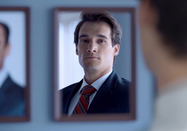 Video Reference: Forehead, Chin, Eyebrow, Coat, Flash photography, Tie, Gesture, Dress shirt, Collar, Suit