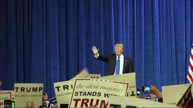 Video Reference: Microphone, Theater curtain, Blue, Curtain, Podium, Spokesperson, Lectern, Tie, Flag, Suit