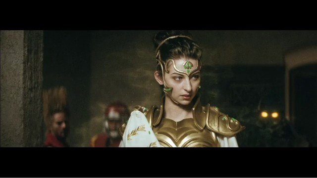 Video Reference: woman, armor, costume, headpiece, fantasy, portrait, indoor, cinematic, historic, dramatic, background blur, gold
