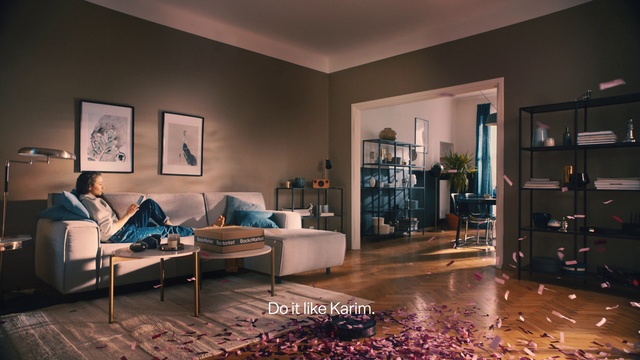 Video Reference: Picture frame, Couch, Furniture, Property, Table, Purple, Lighting, Interior design, Floor, Wood