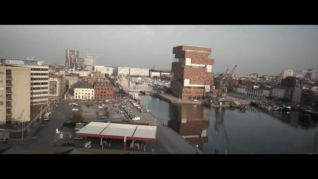 Video Reference: cityscape, aerial, waterfront, canal, harbor, urban, buildings, road, parking, reflection, skyline, industrial, architecture, dock, bridge, hazy