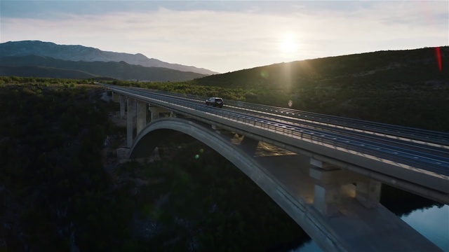 Video Reference: Sky, Cloud, Water resources, Mountain, Car, Road surface, Asphalt, Body of water, Road, Landscape