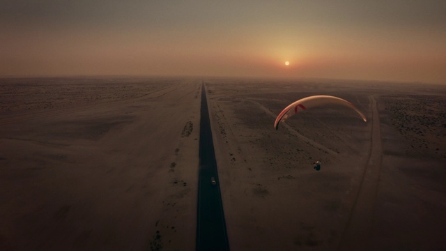 Video Reference: Sky, Atmosphere, Natural environment, Parachute, Air travel, Horizon, Landscape, Paragliding, Sunset, Dusk
