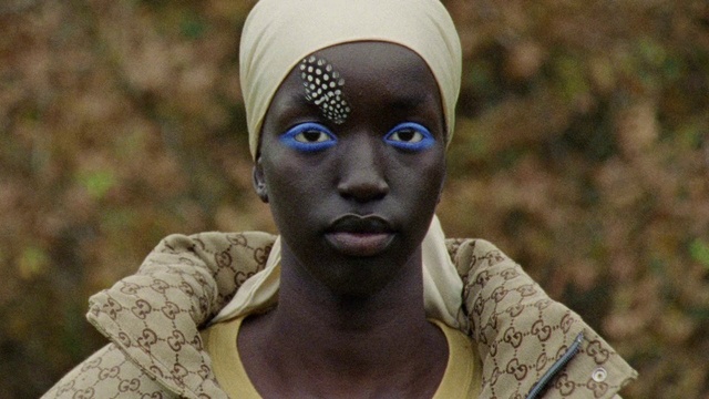 Video Reference: Face, Forehead, Head, Eyebrow, Eye, Neck, Headgear, Eyelash, Adaptation, Tribe