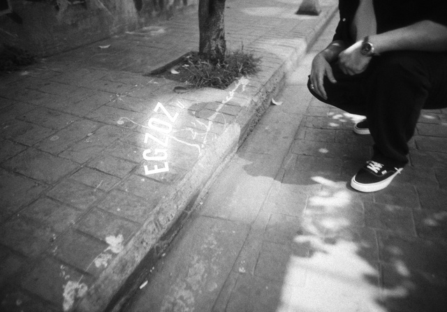 Video Reference: Leg, Water, Black, Road surface, Human body, Flash photography, Black-and-white, Asphalt, Standing, Gesture