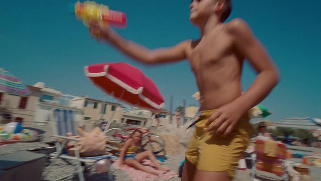 Video Reference: Muscle, People on beach, Net sports, Sky, Shorts, Trunks, Swimwear, Gesture, Volleyball, Leisure